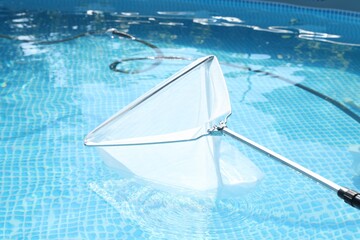 Canvas Print - Cleaning swimming pool with skimmer net, closeup