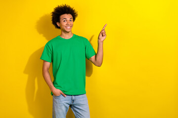 Canvas Print - Photo of handsome good mood guy wear green t-shirt showing emtpy space isolated yellow color background