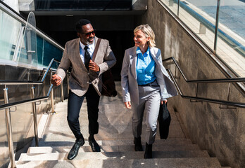 Mauture black businessman and middle aged businesswoman travelling with subway for work - Multiethnic business team going to work at office