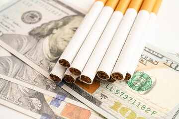 Cigarette on US dollar banknotes, cost, trading, marketing and production, No smoking.