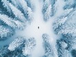 © Maxim Borbut - Aerial photograph of a person lying on a frozen lake in Eibsee, Germany, surrounded by symetric snowy pine forests