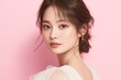 © kenkuza - Beauty portrait of young Asian woman in dress on pink background