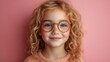 © liliyabatyrova - A young girl with curly hair and glasses is smiling at the camera