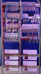 Sticker - Connecting electrical modules using insulated wires in an electrical distribution cabinet. Close-up.