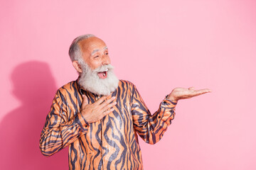 Sticker - Portrait of funky aged man hold empty space offer tiger print shirt isolated on pink color background