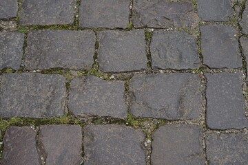 Cobblestone tiles street with big stones, top view. Ancient stone floor. Old pavement