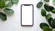 © Farhad - Smartphone showing white screen surrounded by green leaves on white background