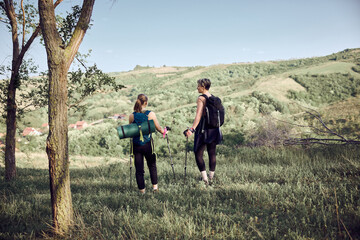 Wall Mural - Two Women Enjoying Getting On Top Of The Mountain