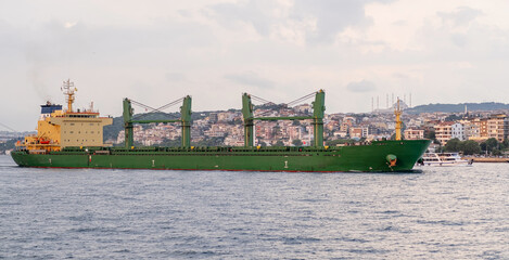 Aufkleber - A large cargo ship travels along the Bosphorus with Istanbul's cityscape visible