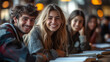 © Anastasia - A group of students smiling as they study together, surrounded by textbooks and notebooks.