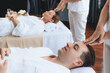 © InfiniteFlow - Caucasian couple enjoying relaxing anti-stress head massage and pampering facial beauty skin recreation leisure in dayspa modern light ambient at luxury resort or hotel spa salon. Quiescent