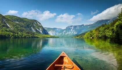 Canvas Print - canoeing in the lake bohinj on a summer day background alps mountains