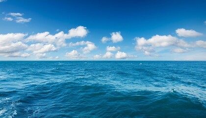 Wall Mural - background with blue sea with ripples and waves and blue sky with blanket of clouds