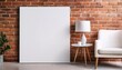 © Reagan - empty canvas mockup on exposed brick wall furnished with a white chair and side table