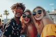 © Mitya - Joyful multiracial friends enjoying a rooftop party with trendy sunglasses and dj entertainment