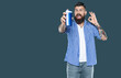© be free - surprised bearded man hold beauty product bottle of shampoo. ok