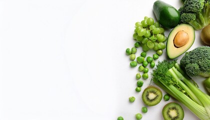 fresh green vegetables variety on a rustic white background from overhead broccoli celery avocado brussels sprouts kiwi peppers peas beans lettuce