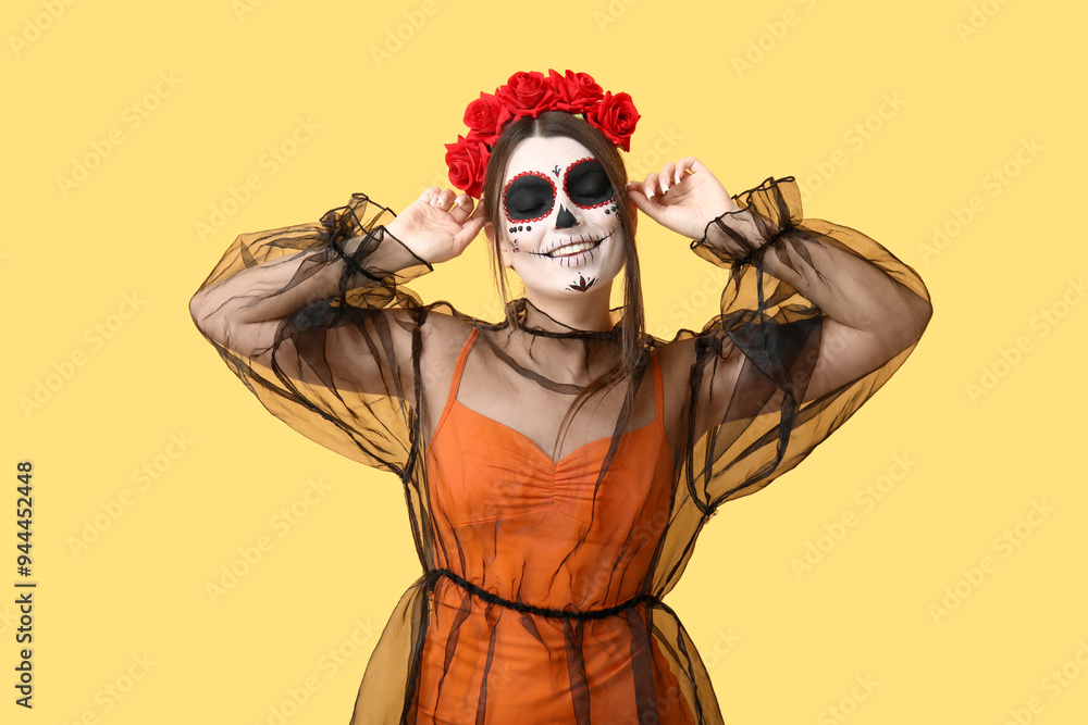 Young woman dressed for Halloween on yellow background