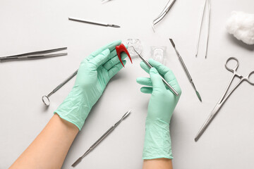 Wall Mural - Dentist with plastic tooth and tools on light background, top view