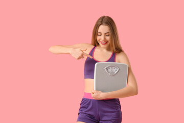 Sticker - Sporty young woman with measuring scales on pink background. Diet concept