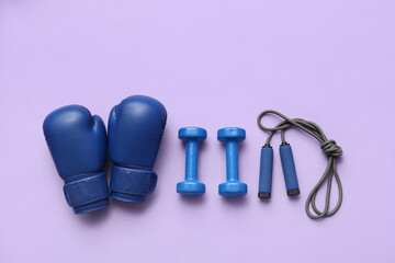 Set of sports equipment on lilac background, top view