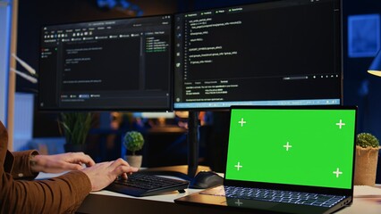 Green screen laptop in home office used by programmer for developing software applications. Mockup notebook used by teleworking IT specialist for programming, camera B close up