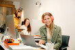© Franci Leoncio - cheerful Smiling businesswoman working in an office wearing headphones