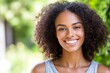© Leo Rohmann - Bright and Cheerful Portrait of a Young Woman with Natural Hair Smiling Outdoors in the Sunshine Embracing the Joy Simplicity and Beauty of a Happy Carefree Day