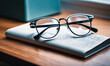 © Miklos - A pair of eyeglasses sit on a book, resting on a wooden table