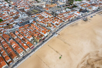 Overhead drone view of Nazare, Portugal, and its beach where the largest wave was surfed