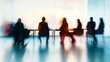 © fotofabrika - Silhouetted figures in a modern conference room during a meeting at dusk