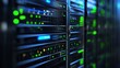 © MakoPoko - High-tech server racks in a modern data center. The sleek metallic towers are stacked neatly, glowing with green and blue lights against a dark background.