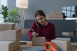 © Jirapong - woman, online seller, using smartphone to calling customers, goals, and drive success in her e-commerce business