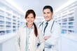 © BillionPhotos.com - Portrait of two doctors smiling standing in medical consultation.