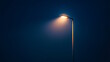 © Artomoro - This image shows a street lamp with a bright yellow light in the dark,space for text