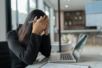 Burnout concept. Asian Business woman touching forehead having headache boring job and tired emotional pain and professional person depressed over risk