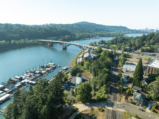 A city view of a river with a bridge and a few houses