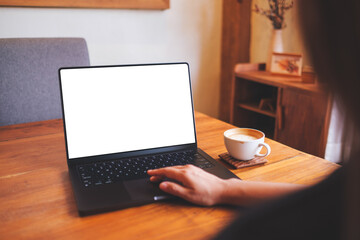 Wall Mural - Mockup image of a woman using and touching on computer laptop touchpad with blank desktop screen at home