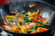 © sbjshah - Vibrant color vegetable stir-fry in a hot wok