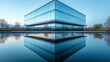 © Наталья Евтехова - A symmetrical reflection of a modern glass building in a calm water surface, creating a mirror image of the architecture, with copy space