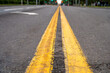 © YuTphotograph - The yellow dividing line on the road surface. The road is in the center of the city. Blur