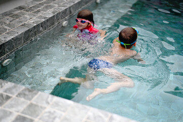 Girl and boyin swimming pool