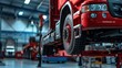 © inthasone - Truck on a lift at a truck service station. close-up of a car's undercarriage.