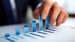 © Thavesak - Businessman Touching Upward Bar Graph for Sales Growth Success on White Background