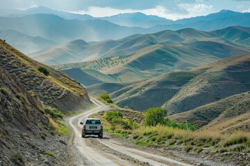 Wall Mural - a car driving down a dirt road in the mountains