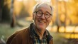 © Ruslan Gilmanshin - An older man in glasses and a plaid shirt smiles for the camera