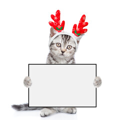 Poster - Cute kitten dressed like santa claus reindeer  Rudolf holds blank white board. isolated on white background