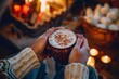 © alisaaa - Keeping Warm with Hot Chocolate Point of view shot of a mature woman keeping warm with a cup of hot chocolate by the fire.