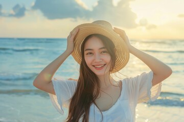 Wall Mural - A woman relaxing on a sunny beach, wearing a straw hat and enjoying the warm weather