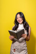© Wasana - A woman is reading a book while smiling
